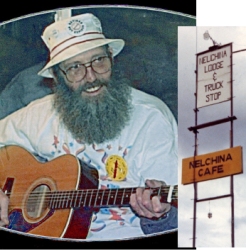 man with gray beard playing guitar